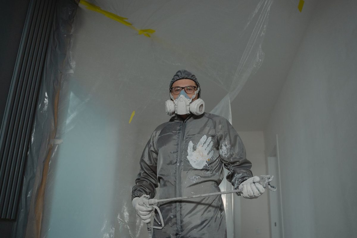 Painter at work on a wall